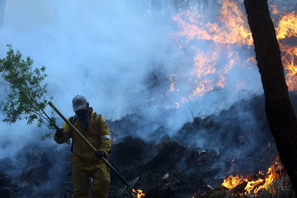 A fireman fights a massive fire at "La P